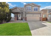 Charming two-story home featuring a well-maintained lawn and a covered front porch at 9378 Longstone Dr, Parker, CO 80134