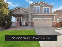 Charming two-story home featuring a two-car garage and inviting covered porch at 9378 Longstone Dr, Parker, CO 80134