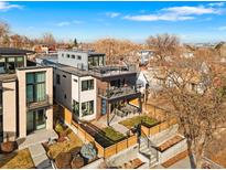 Stunning aerial view of the modern home with a rooftop deck and a fenced front yard at 1845 W 33Rd Ave, Denver, CO 80211
