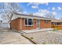 Charming brick home featuring a well-maintained lawn and a cozy front porch area at 860 Zenobia St, Denver, CO 80204