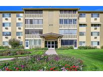 Inviting condo building with lush landscaping, well-maintained lawn, and prominent building number display at 635 S Alton Way # 6A, Denver, CO 80247
