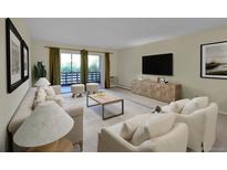 Bright living room with neutral tones, balcony access, modern furniture and decor at 635 S Alton Way # 6A, Denver, CO 80247