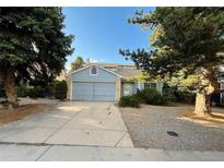 Charming single Gathering home featuring a two-car garage, and complemented by mature trees and landscaping at 17969 E Brown Pl, Aurora, CO 80013