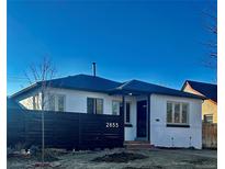 Charming single-story home with a dark privacy fence, white brick facade, and well-manicured front yard at 2855 Albion St, Denver, CO 80207