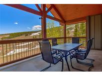 Mountain view balcony with table and chairs is perfect for enjoying the outdoors at 107 Ski Watch Rd # 32, Breckenridge, CO 80424