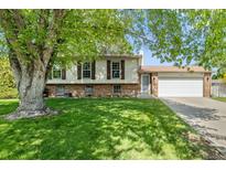 Charming two-story home with a well-manicured lawn and a two-car garage at 11199 Dahlia Pl, Thornton, CO 80233
