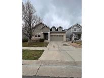 Charming two-story home featuring a brick-accented garage and well-maintained front yard with mature tree at 1137 S Coolidge Cir, Aurora, CO 80018