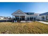 Charming single-story home with a covered porch and black metal fence on a sunny day at 367 Josef Cir, Fort Lupton, CO 80621