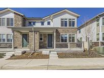 Charming two-story home featuring stone accents and a welcoming front porch at 8833 Meade St, Westminster, CO 80031