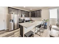 Modern kitchen with stainless steel appliances, granite countertops, and stylish cabinets at 8833 Meade St, Westminster, CO 80031