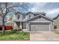 Charming two-story home featuring a gray exterior, well-maintained lawn, and an attached two-car garage at 5237 S Malaya Way, Centennial, CO 80015