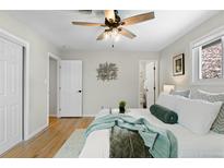 Bright bedroom featuring hardwood floors, a ceiling fan, and a calming color palette at 3190 Ward Ct, Wheat Ridge, CO 80215