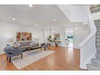 Bright living room features hardwood floors, a neutral color scheme, and an open layout for entertaining at 6102 E Yale Ave, Denver, CO 80222