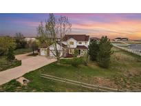 Beautiful two-story home with a three car garage, lush lawn and a large front yard at 28700 E 160Th Pl, Brighton, CO 80603