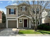 Charming two-story home with a well-maintained lawn and a two-car garage, creating an inviting curb appeal at 10676 Forester Pl, Longmont, CO 80504