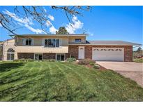 Charming home featuring a well-manicured lawn, brick accents, and a two-car garage at 19260 Spring Valley Rd, Monument, CO 80132