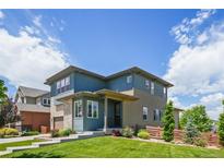 Stylish two-story home with a well-manicured lawn, stone accents and beautiful landscaping at 198 Starlight Cir, Erie, CO 80516