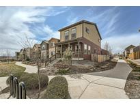 Charming two-story home featuring a cozy front porch and well-manicured landscaping, complemented by a neighborhood walking path at 12770 Tamarac St, Thornton, CO 80602