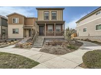 Charming two-story home featuring a covered porch and landscaped front yard at 12770 Tamarac St, Thornton, CO 80602