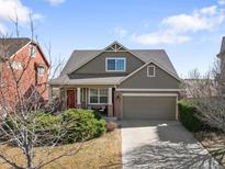 Charming two-story home featuring a well-manicured lawn and an attached two-car garage at 11060 River Oaks Ln, Commerce City, CO 80640