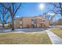 Two-story brick apartment building featuring a well-maintained lawn and sidewalk at 765 S Alton Way # 6B, Denver, CO 80247
