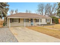 Charming single-story home with a well-manicured front yard and covered entryway at 956 Racine St, Aurora, CO 80011