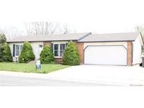 Ranch home with tidy front yard and a two car attached garage at 11068 Eudora Cir, Thornton, CO 80233