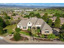 Stunning aerial view of a grand estate home with lush landscaping and mountain views at 4541 Tierra Alta Dr, Castle Rock, CO 80104