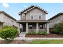 Charming two-story home with a cozy front porch and well-maintained landscaping at 5716 Boston Ct, Denver, CO 80238