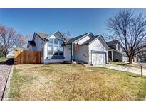 Charming home with blue accents, a well-kept lawn, and an attached two-car garage at 3983 Cambridge Ave, Broomfield, CO 80020