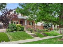 Charming two-story brick home with landscaped front yard and inviting curb appeal at 538 Cook St, Denver, CO 80206