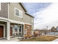 Charming exterior of a two-story home with a well-manicured lawn, stone accents, and a welcoming front porch at 12888 Jasmine St # F, Thornton, CO 80602