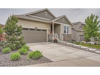 Charming single Gathering home features a two car garage and covered front porch at 8153 S Ider Ct, Aurora, CO 80016