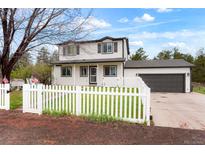 Charming home with a white picket fence and a well-maintained front yard at 37625 Pheasant Run, Elizabeth, CO 80107
