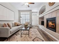 Comfortable living room featuring a cozy fireplace and neutral decor at 9733 E Carolina Pl, Aurora, CO 80247