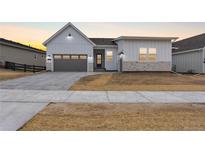 Charming single Gathering home featuring a 2-car garage and stone accents at 7392 Timberstone St, Castle Pines, CO 80108