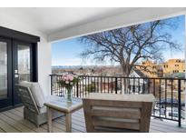 Relaxing balcony seating area offers city views with comfortable chairs and a small table at 2524 Zenobia St, Denver, CO 80212