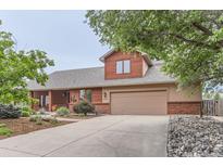 Charming home featuring a two-car garage, wood siding, and an inviting landscaped front yard at 5420 Crestone Cir, Boulder, CO 80301