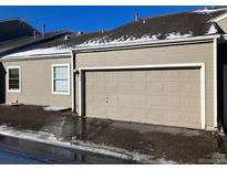 Attached two-car garage providing convenience and secure parking at 5866 W Asbury Pl, Lakewood, CO 80227