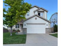 Charming two-story home featuring a two-car garage, landscaped yard, and a welcoming front porch at 4522 S Jebel Way, Centennial, CO 80015