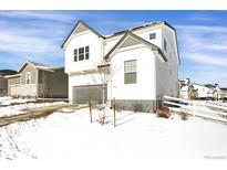 Two-story home with white siding, gray accents, and a snowy front yard at 2523 Villageview Ln, Castle Rock, CO 80104