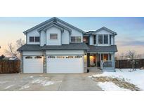 Charming two-story home with a three car garage, stone accents, covered front porch, and tasteful trim at 4286 S Cole St, Morrison, CO 80465