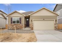 Charming single-Gathering home featuring stone accents, neutral siding, and a two-car garage at 874 Ledge St, Lochbuie, CO 80603