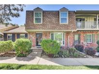 Charming brick townhouse with a well-maintained front yard and a cozy, inviting entrance at 8871 E Amherst Dr # B, Denver, CO 80231