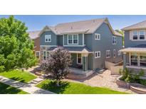 Charming two-story home with landscaped yard, porch, and a combination of stone and vinyl siding at 2488 Lake Vista Dr, Broomfield, CO 80023
