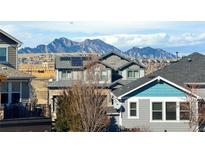 Beautiful multi-story home with solar panels against a scenic mountain backdrop at 8726 Gardenia Cir, Arvada, CO 80005