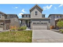 Charming two-story home with a two-car garage, landscaped yard, and welcoming front porch at 24555 E Ohio Dr, Aurora, CO 80018