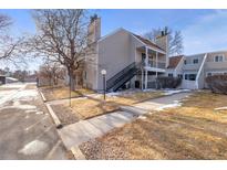 Inviting townhouse featuring a balcony, neutral siding, and a well-maintained yard at 13633 E Yale Ave # B, Aurora, CO 80014