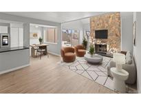 Bright living room featuring stone fireplace, neutral walls, and access to outdoor balcony at 13633 E Yale Ave # B, Aurora, CO 80014