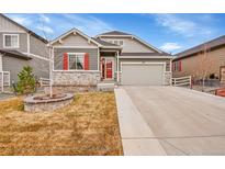 Charming two-story home featuring stone accents, a two-car garage, and a well-maintained front yard at 5190 Ditmars Trl, Castle Rock, CO 80104